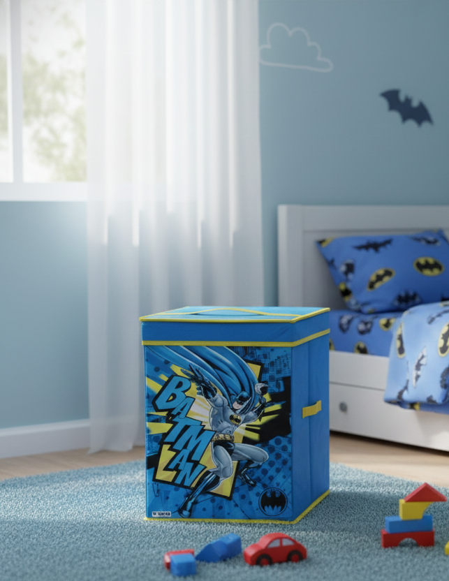 Children's bedroom with blue bedding and toy box, featuring superhero design.